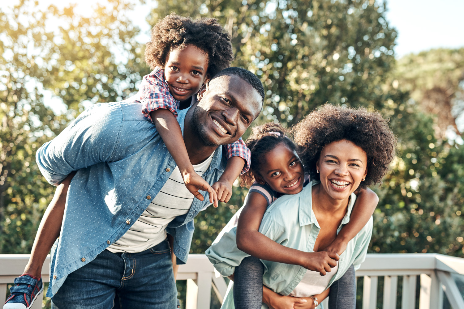 African-American family smiling outside and having fun