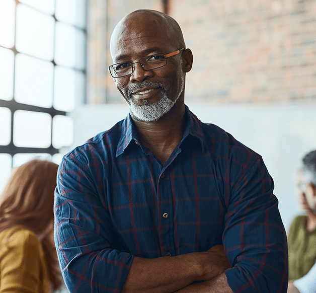 man smiling and folding his arms