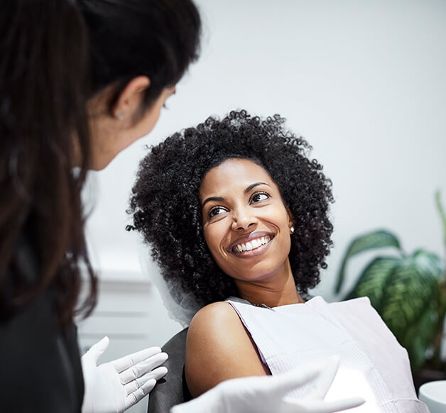 woman speaking with her dentist