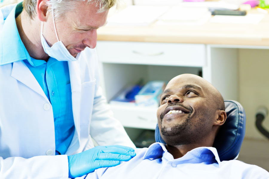 male patient discusses crowns and bridges with the dentist