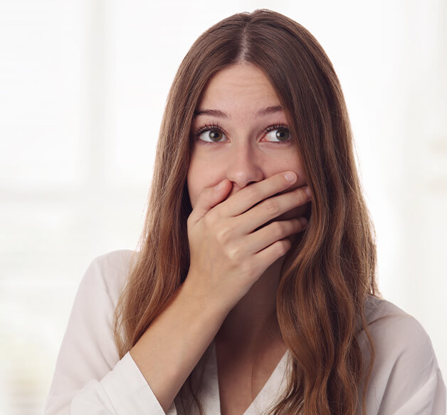 woman covering up her mouth