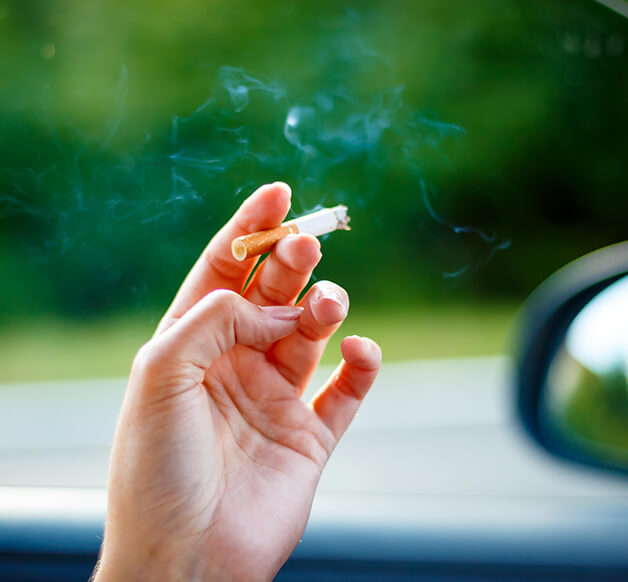 closeup of a person holding a cigarette in thier hand