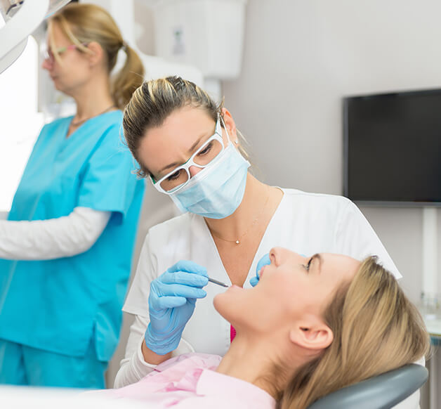 doctor examining a patient's mouth