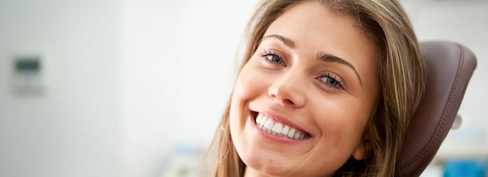 smiling woman sitting in a dental chair