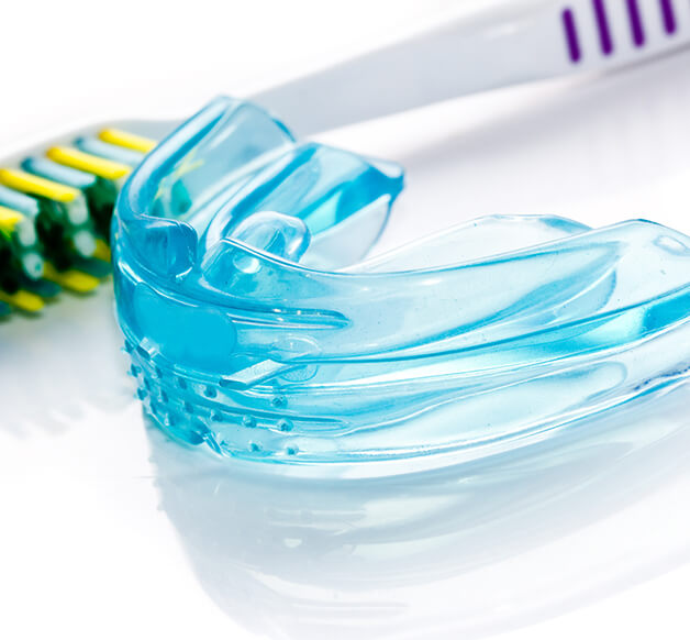 mouthguard next to a toothbrush