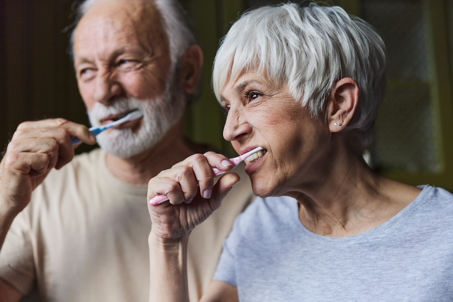 senior brushing teeth because oral health linked with cognitive decline