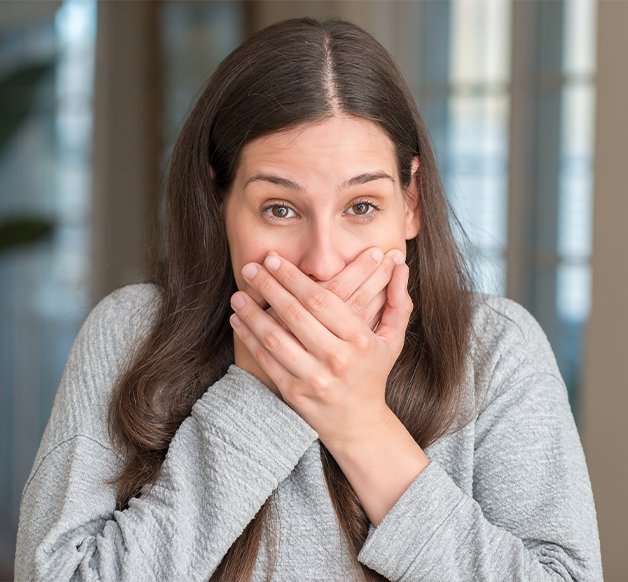 woman covering up her mouth